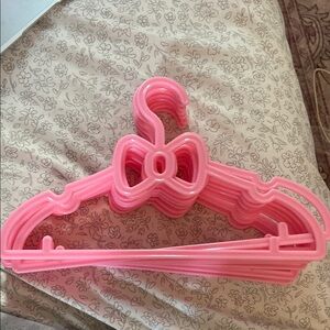 NWOT pink bow-shaped hangers (set of 10)